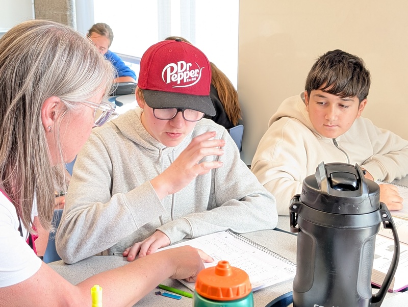 Teacher assisting students in math class