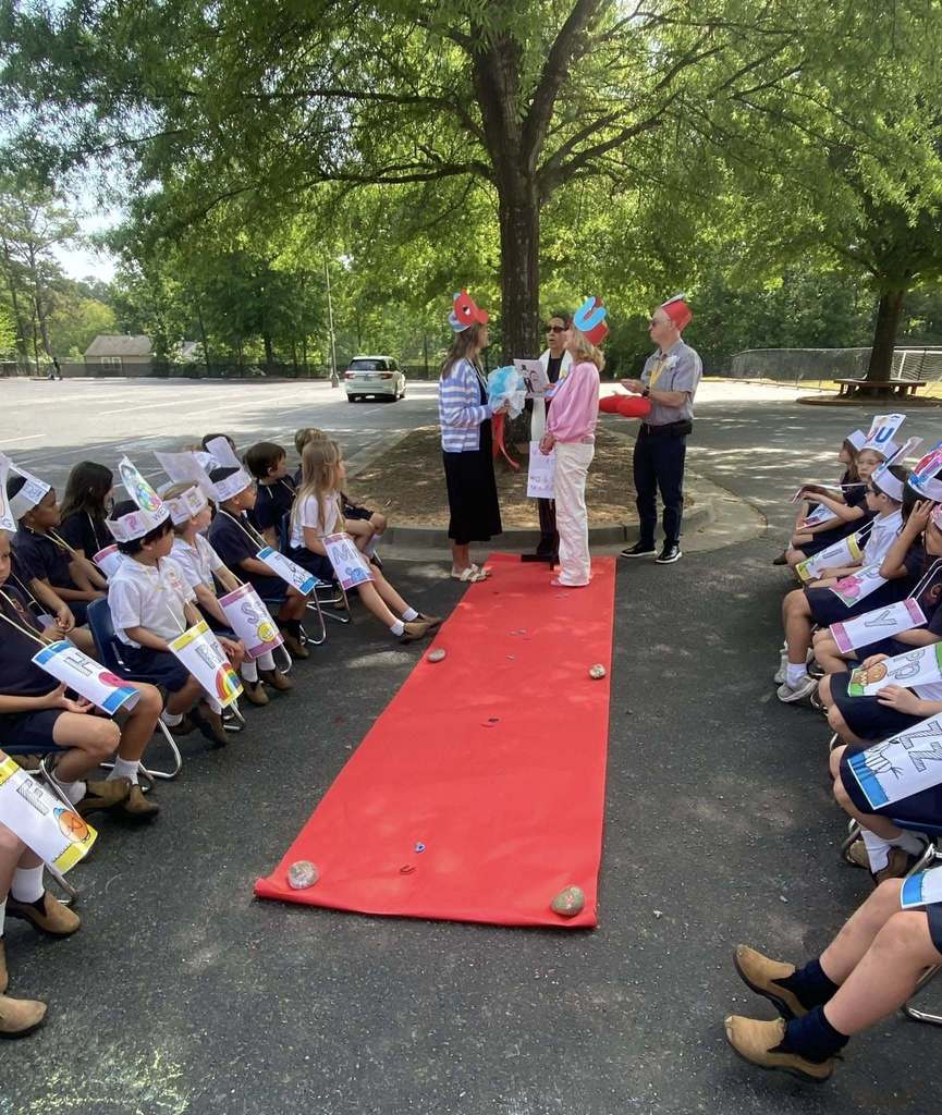 Aisle of Q/U wedding with kindergarten students watching from audience 