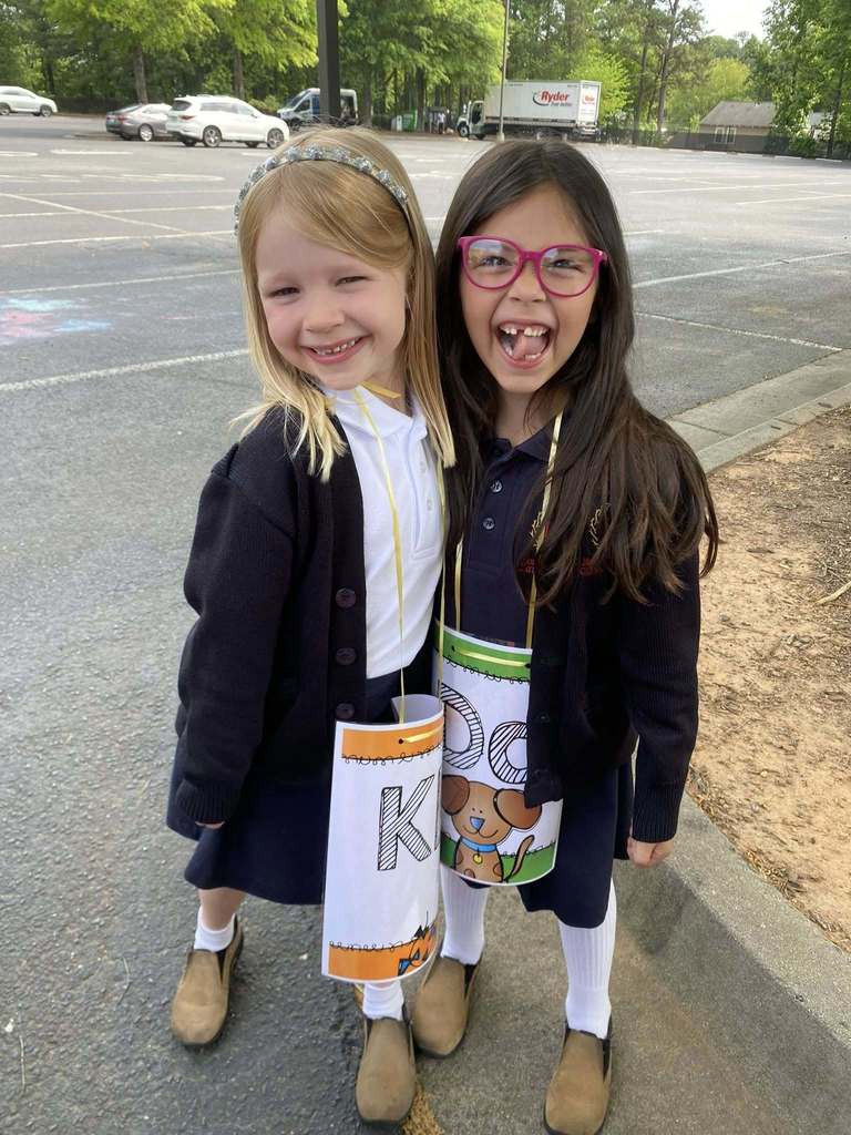 kindergarten students wearing letter signs at Q/U wedding 