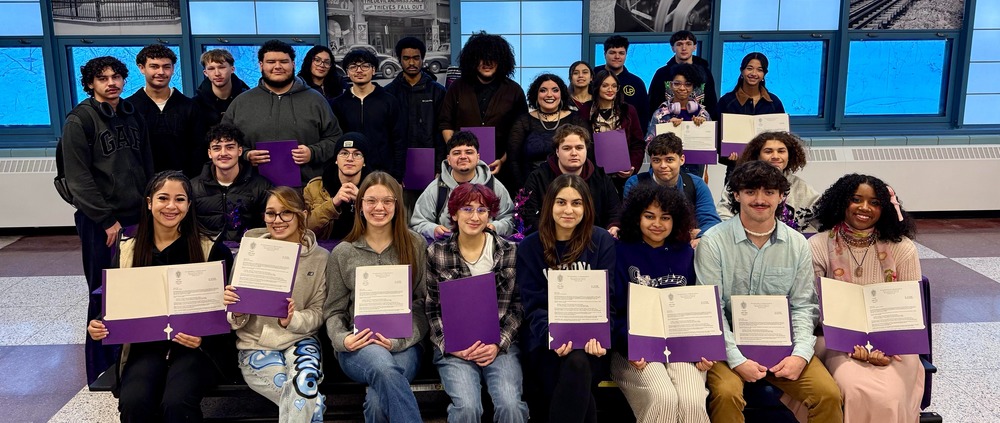 33 students pose with their letters