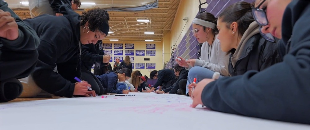 Students contribute to a banner