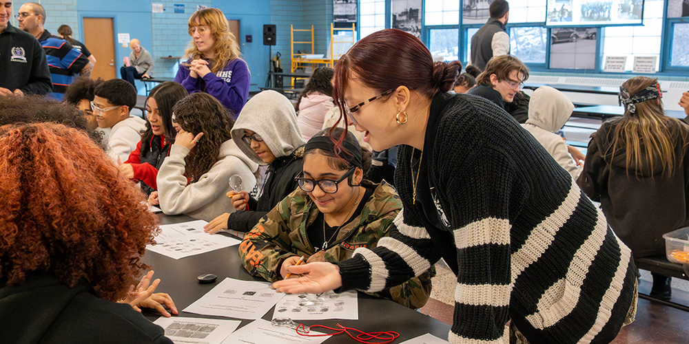 Group of students working together on a project in cafeteria