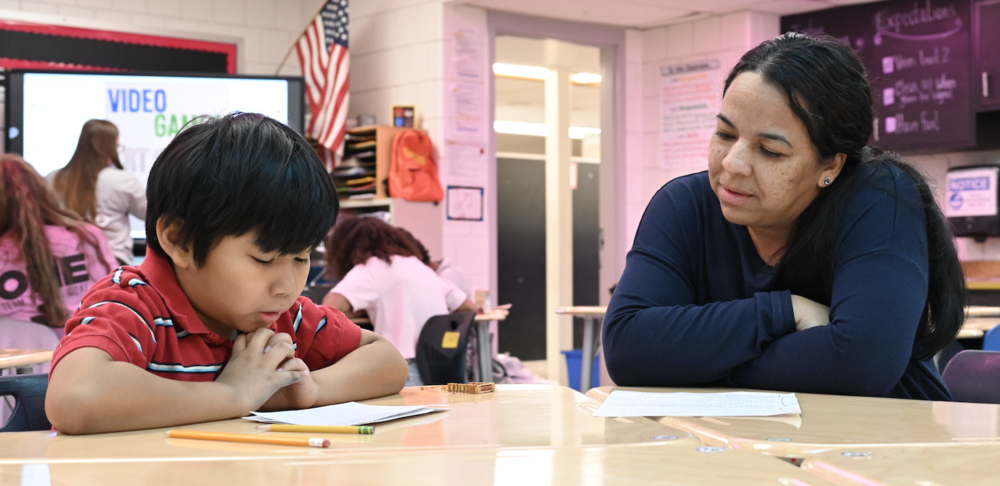 Student and staff review a written assignment