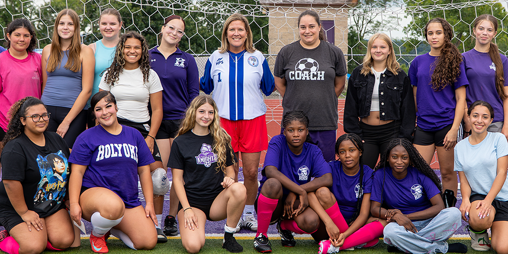 Girls Soccer Team with coach and superintendent