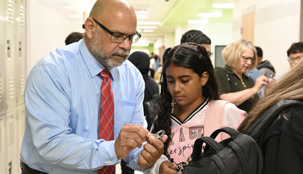 Roberto Vincente helps a student with her combination lock