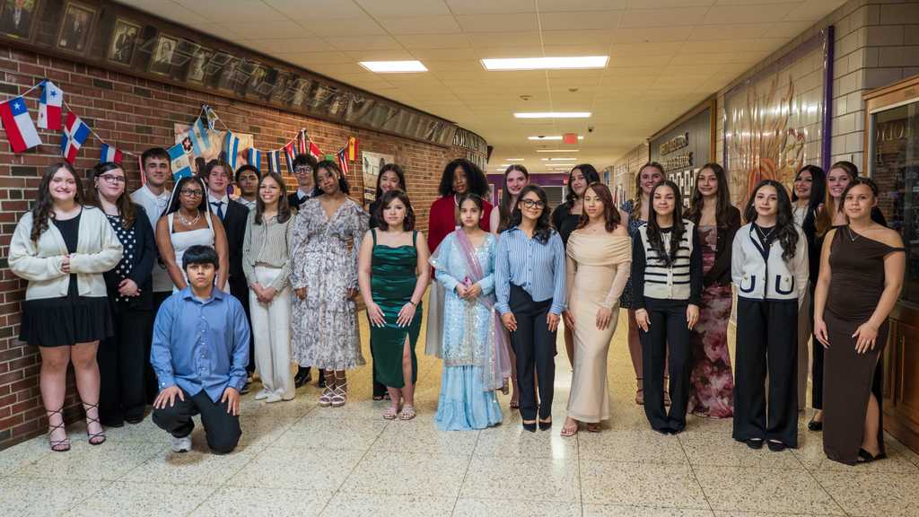 Photo of 25 sophomores poing for photo before the ceremony
