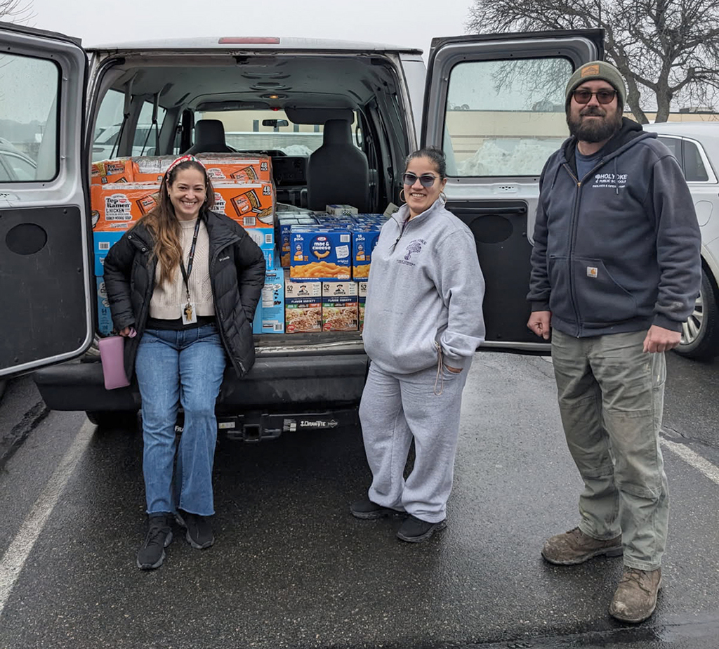 People standing near truck packed with food supplies