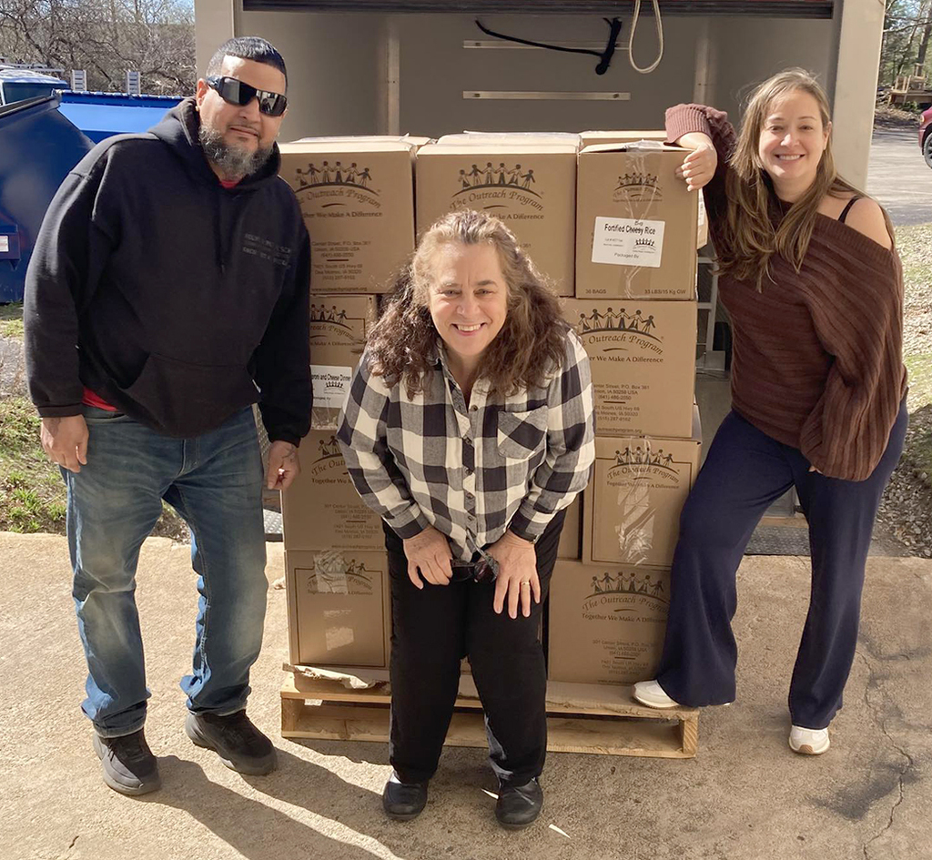 People standing near boxes of food supplies