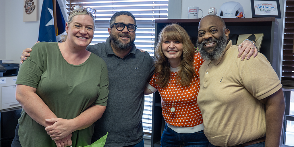Four educators standing together
