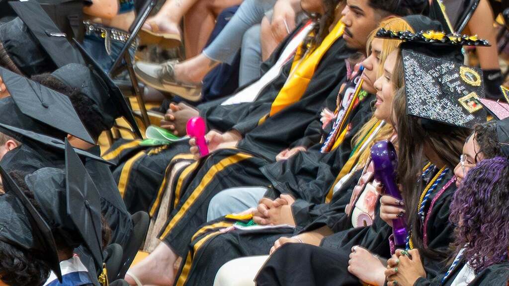Graduates watching a speech