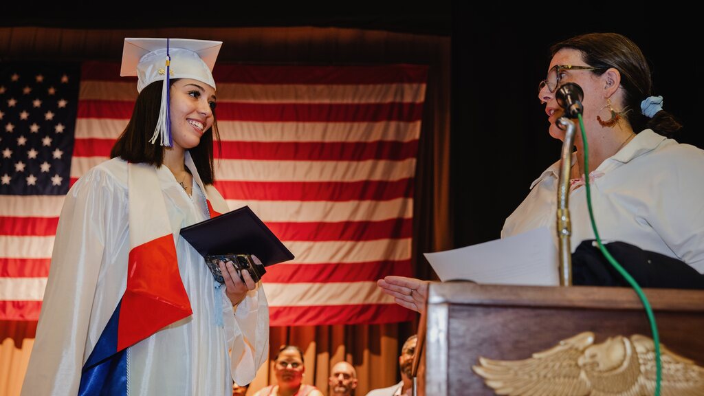 Graduate smiles after receiving her diploma.
