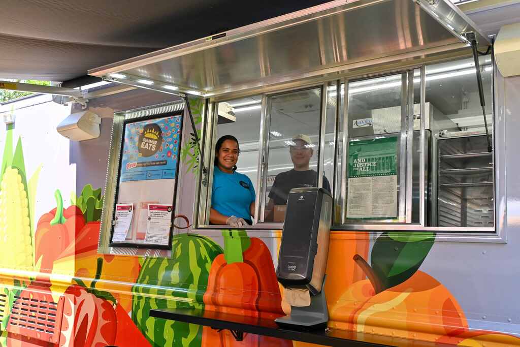 workings smiling inside their food truck