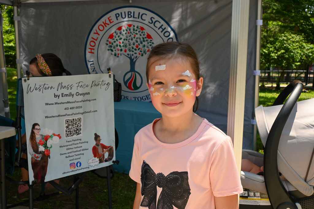child standing posing showing face paint of clouds