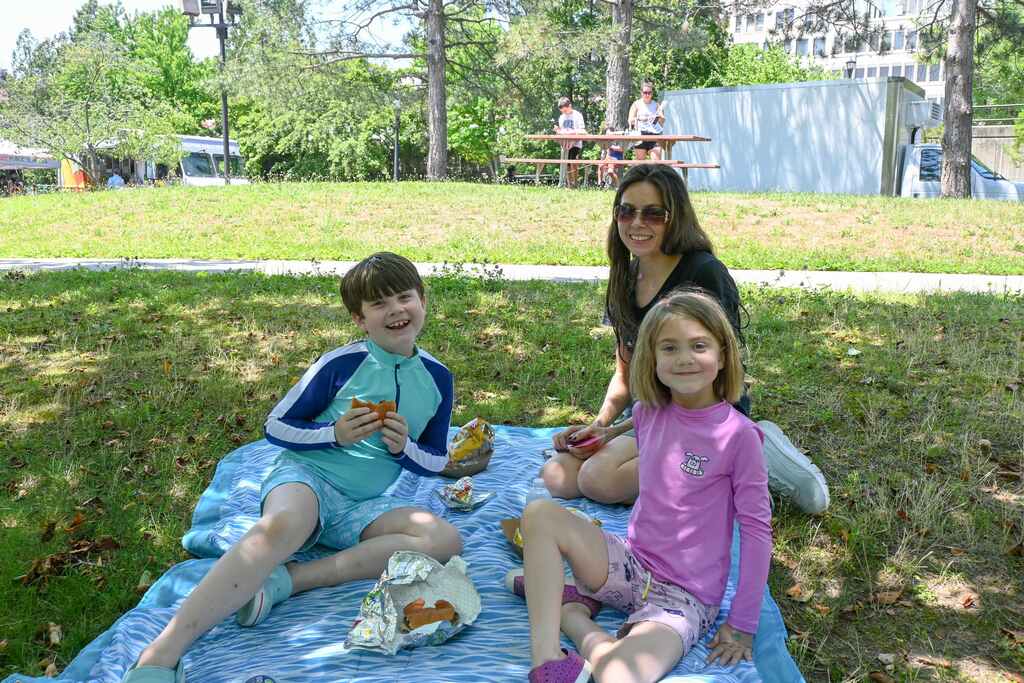 family sitting on grass having a picnic