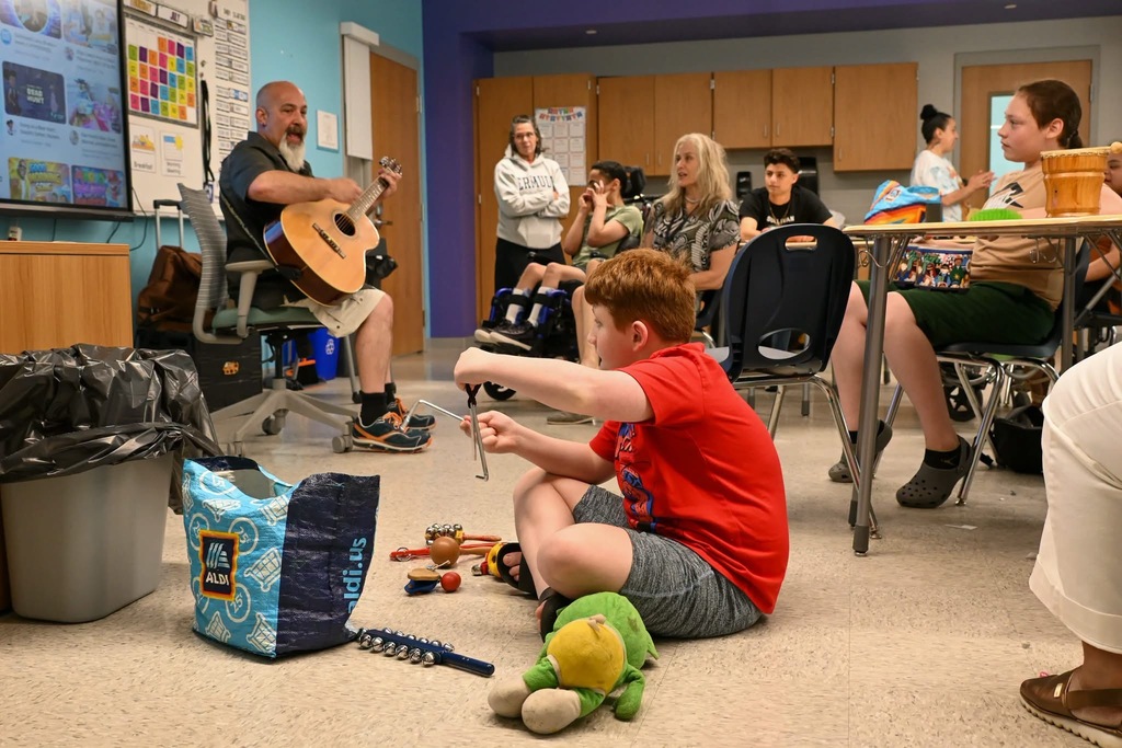 music class with students playing instruments 
