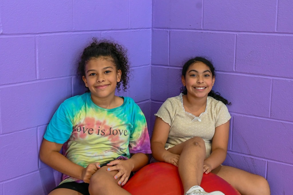 2 students smiling for a photo in gym class