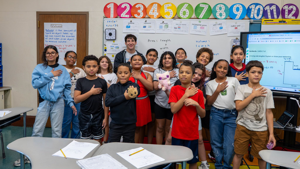 group of students standing posing with their hand over their heart for the 9/11 25th anniversary
