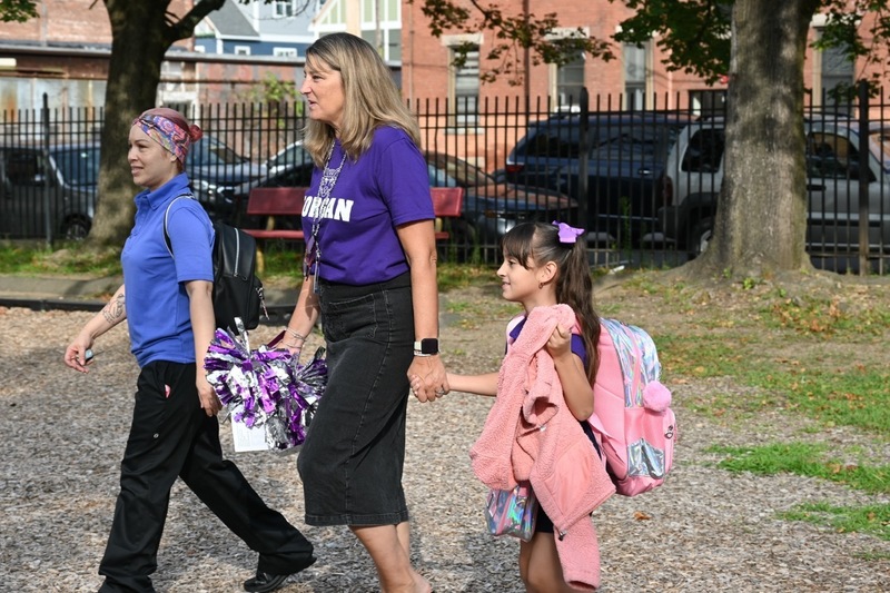 Miss Julie walks a student to her calss