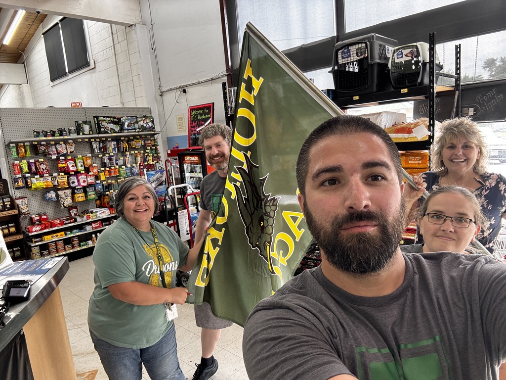 Teachers take a selfie with a Dragon Flag