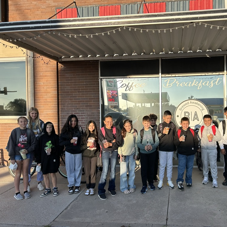 students in front of a coffee shop