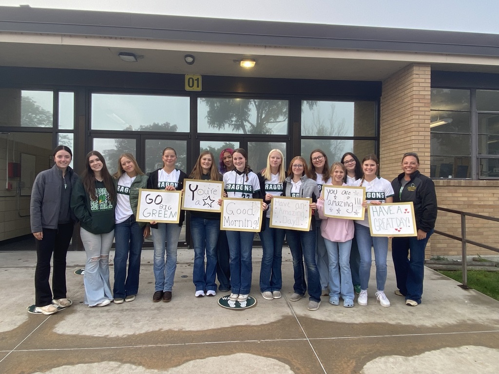 Softball team holds up spirit signs 