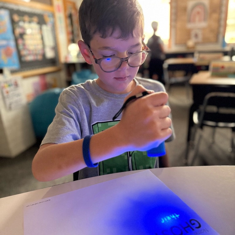 boy writes on paper