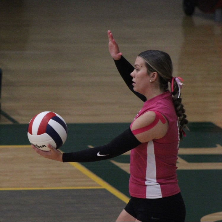 girl prepares to hit ball