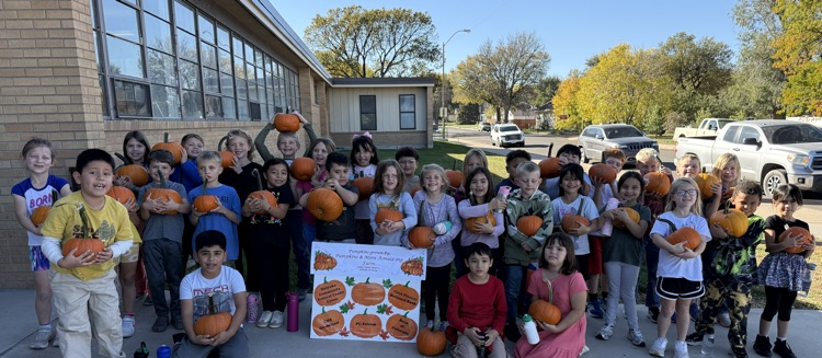 students holding pumpkins 