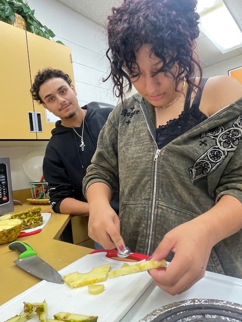 girl cutting pinapple