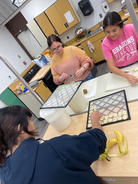 girls cutting banana 