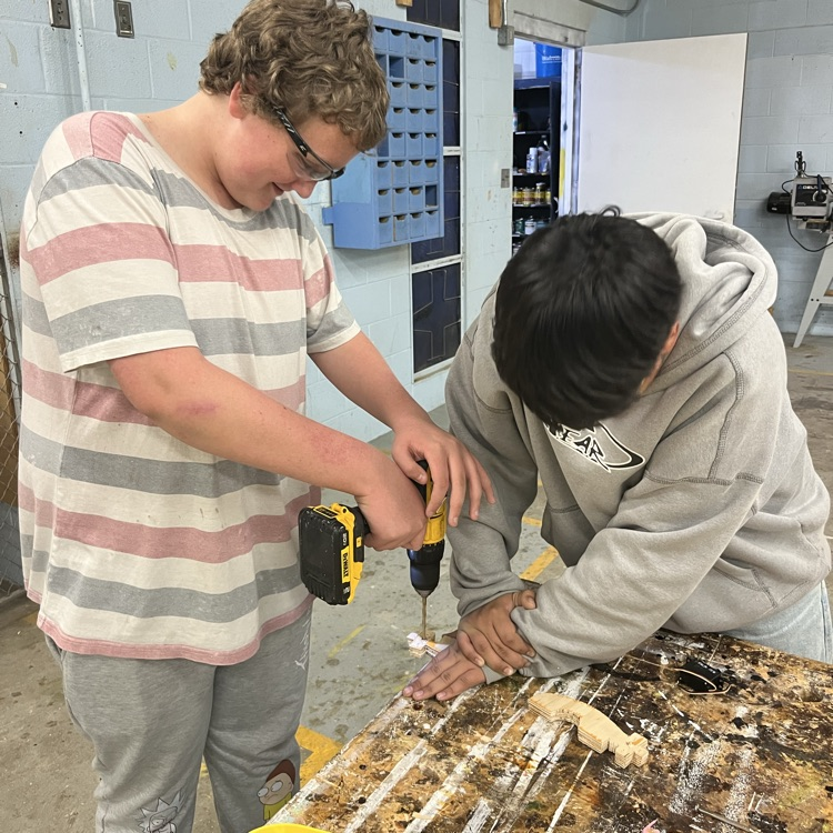 boys holding a drill 