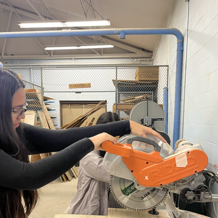 girl pushing saw down