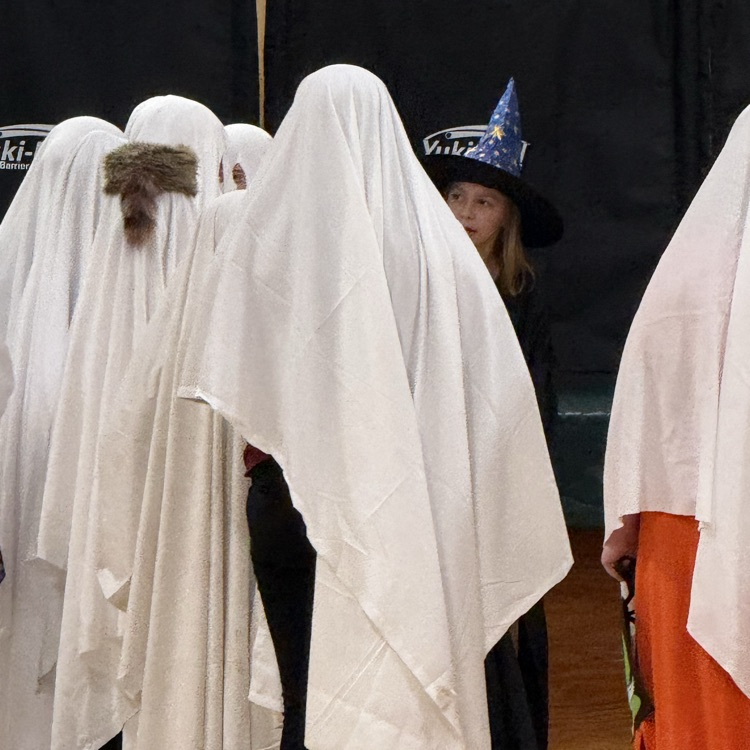 students wearing sheets dressed as ghosts