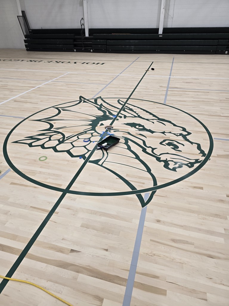 Here are the most recent photos of the Old Gym Project. All of the lines have been painted, they are cleaning up today, and will put the first sealant coat on the entire floor on Thursday.  It will cure for a few days, and they will lightly sand the floor before they put the second coat of sealant on. The floor will cure a few days, they will sand it lightly again and place the last coat of sealant on the floor early next week.  The last sealant coat will cure for 10 to 12 days, and the gym should be ready for use around Dec. 1st.
