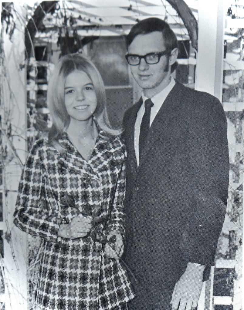 a young man and a young woman standing for a picture.