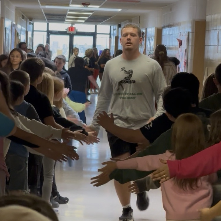 student getting high-fives from other students
