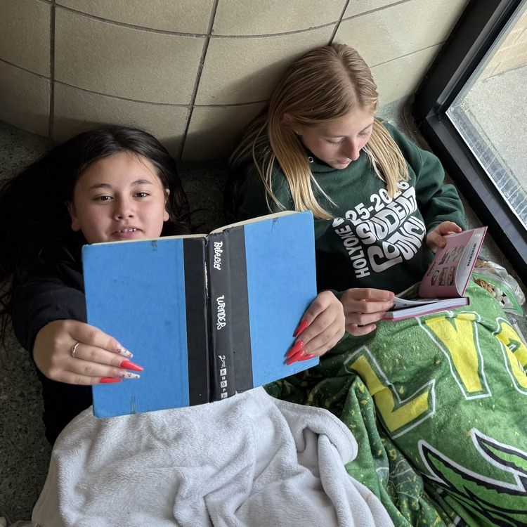students reading in a hallway 