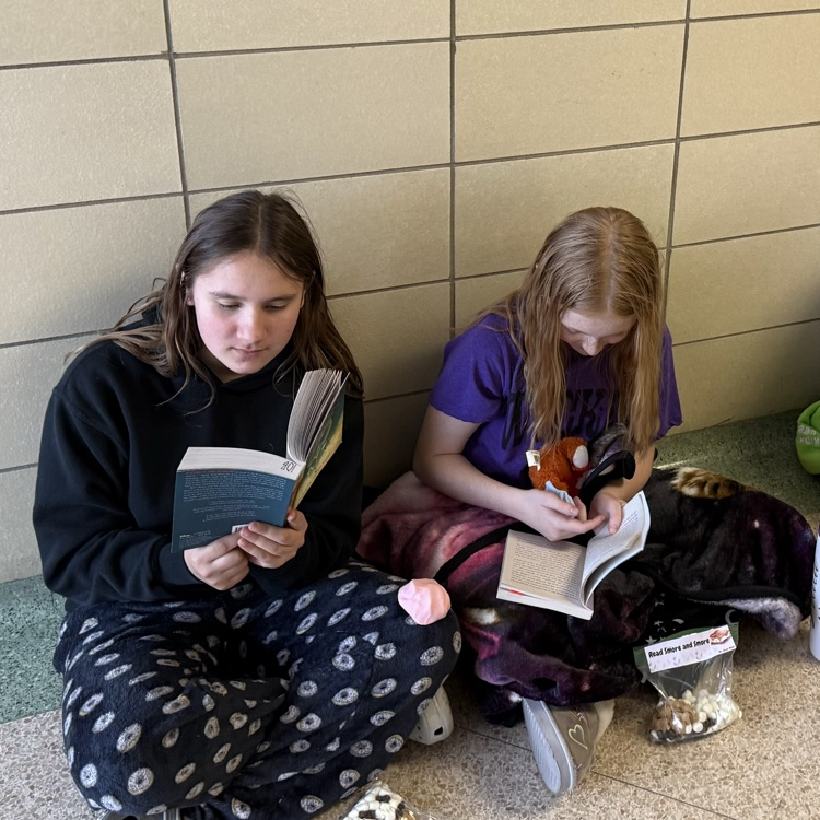 students reading in a hallway 