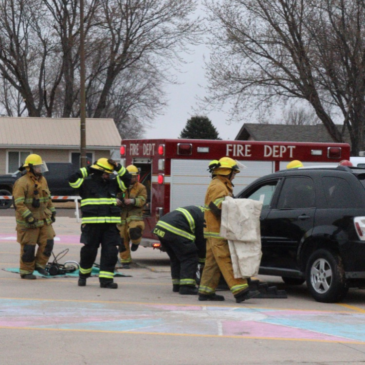 firefighters work on car