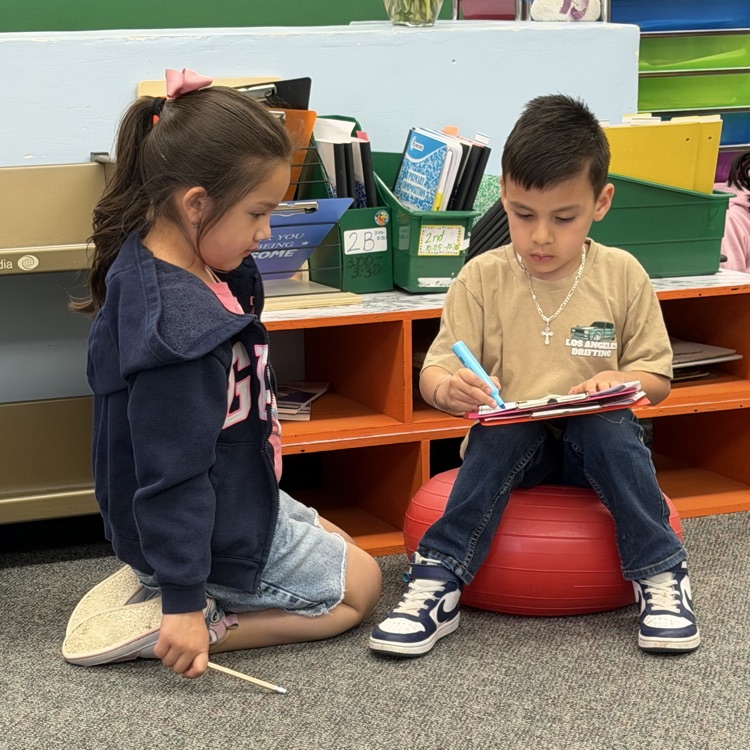 Students reading schoolwork.