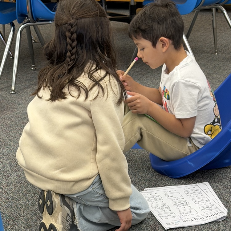 Students reading schoolwork.