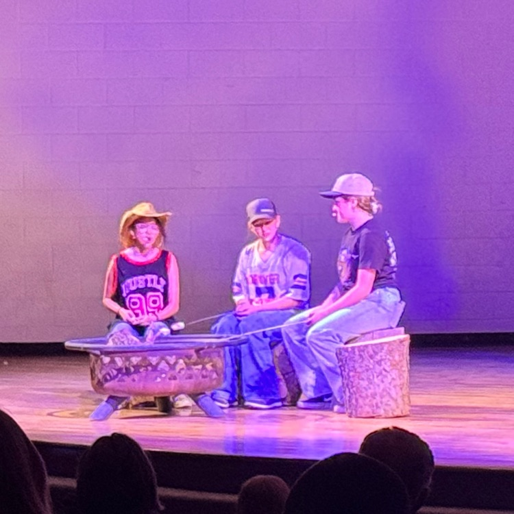 Students acting on stage.