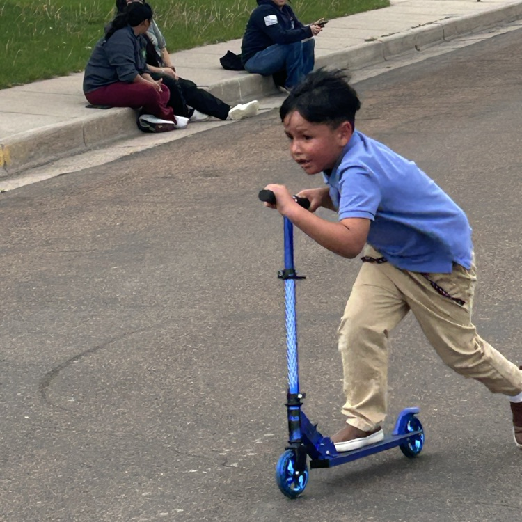 boy riding a scooter 