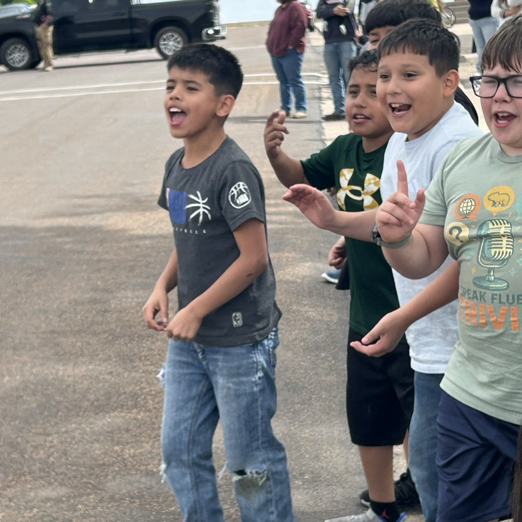 students cheering on the bike riders