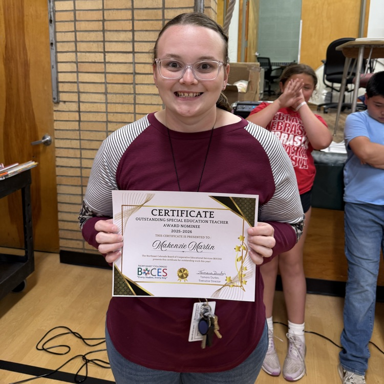 teacher holding a certificate