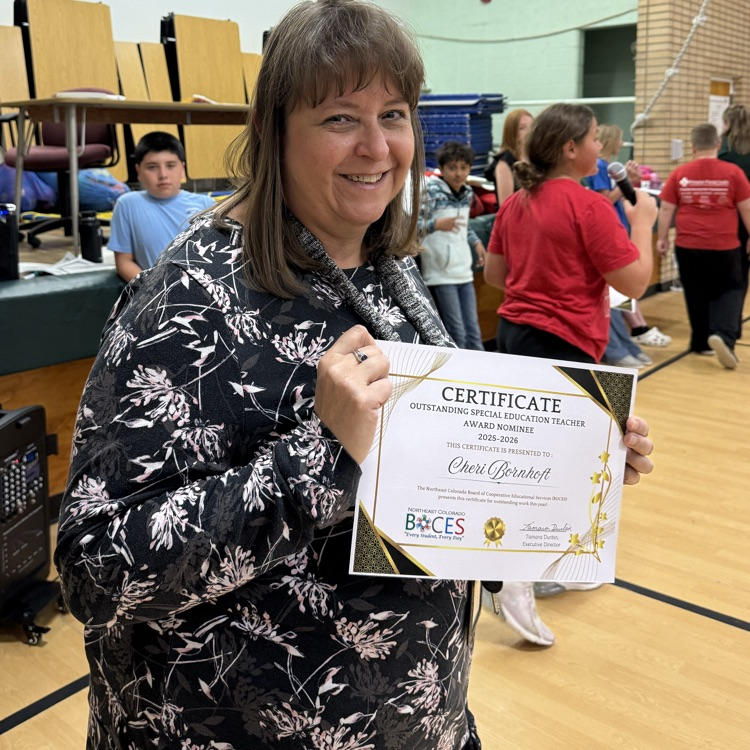teacher holding a certificate