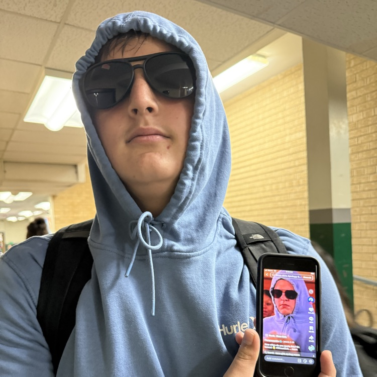 student poses with a picture from the interwebs
