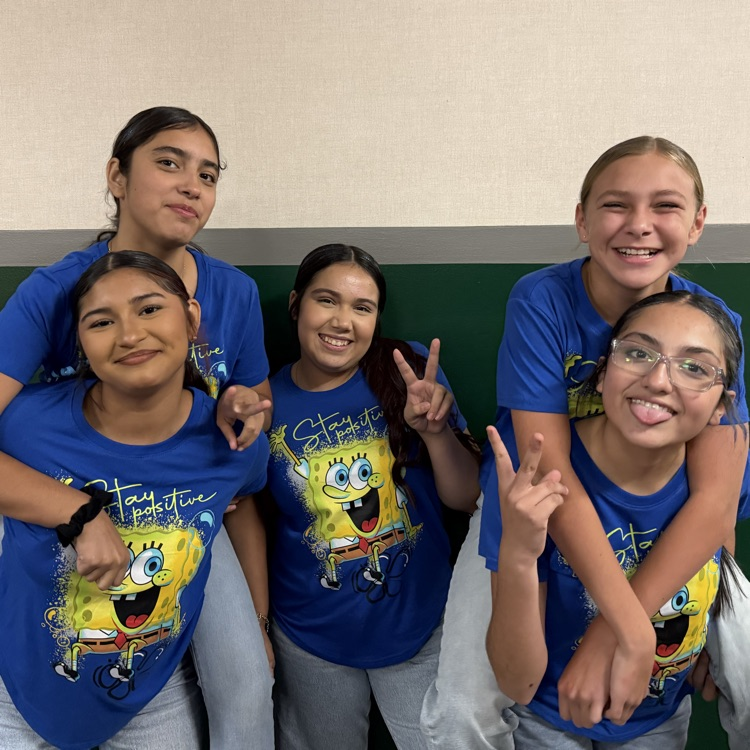 five girls dressed in matching t-shirts