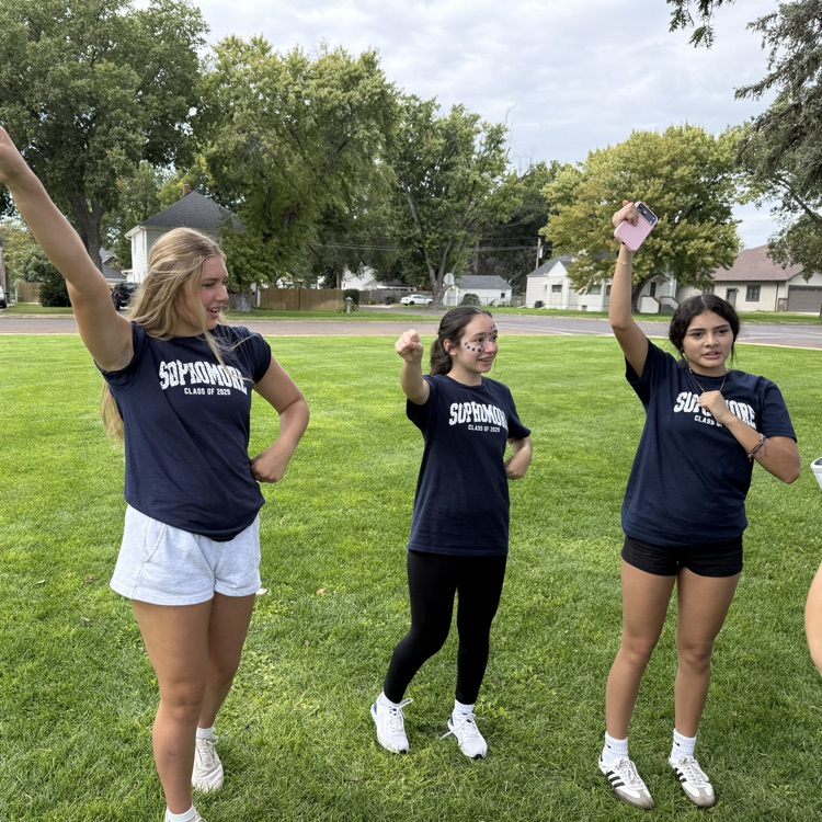 groups of students hang out together on the grass field