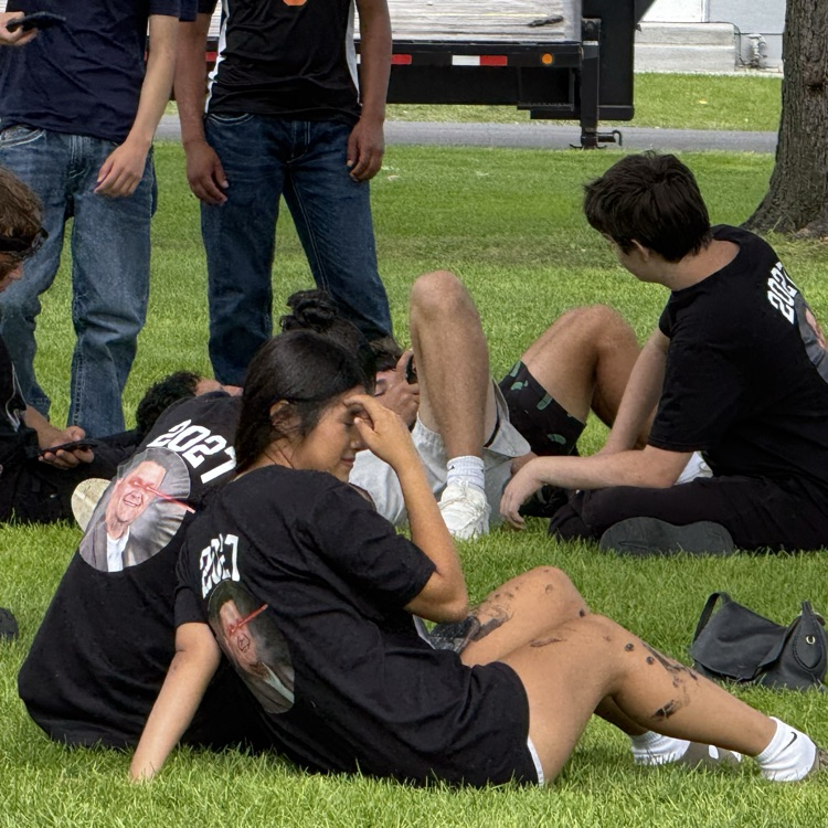 groups of students hang out together on the grass field